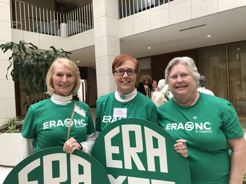 Three AAUW members in green ERA Tshirts with green "ERA YES" rounds.